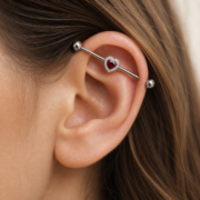 G23 Titanium Heart Crystal Industrial Barbell Earring worn on ear in clean window daylight