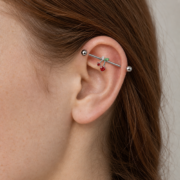 G23 Titanium Cherry Crystal Industrial Barbell Earring worn on ear in clean window daylight