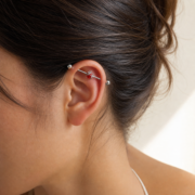 G23 Titanium Spider Crystal Industrial Barbell Earring worn on ear in clean window daylight
