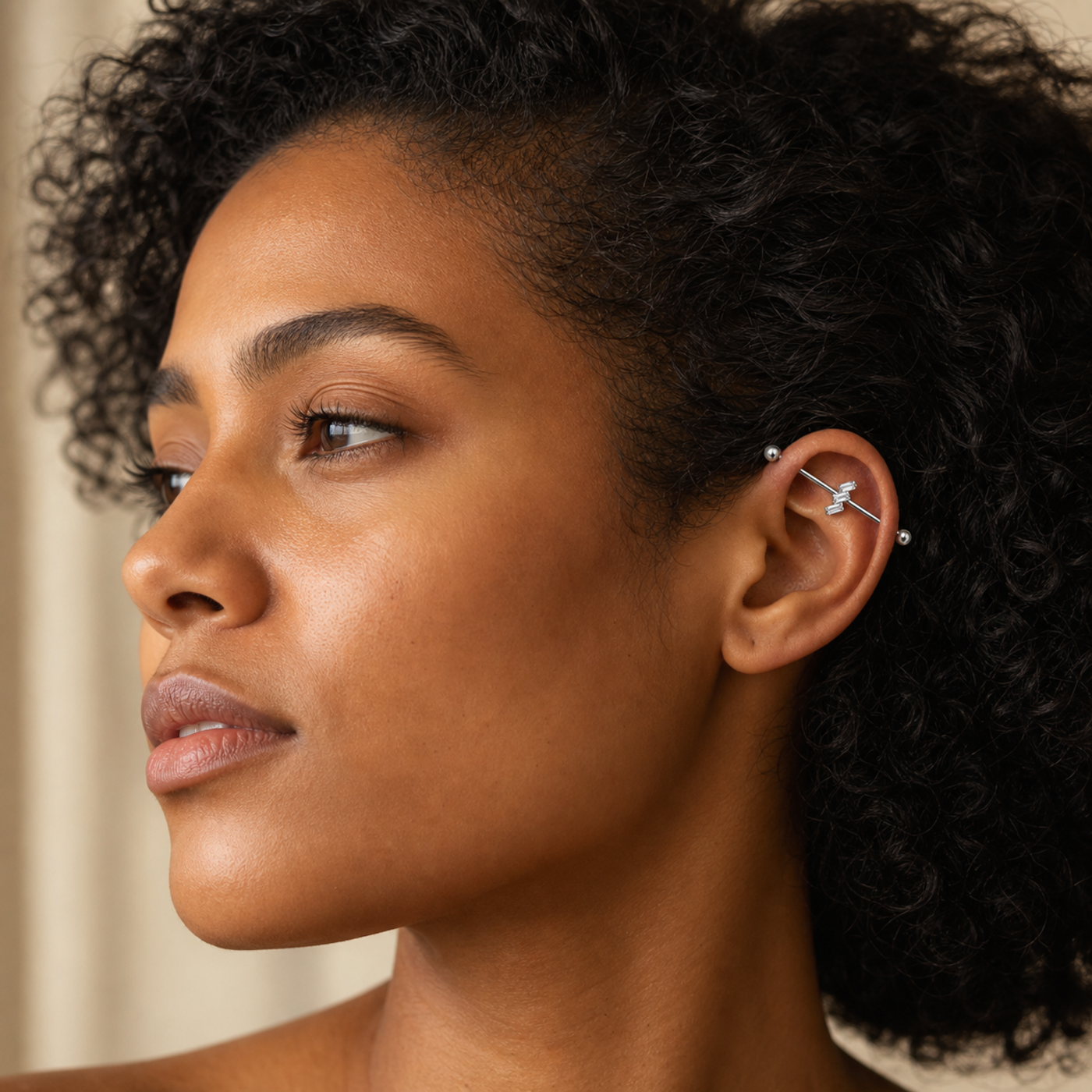 G23 Titanium Three Baguette Industrial Barbell Earring in Silver worn on ear in clean window daylight