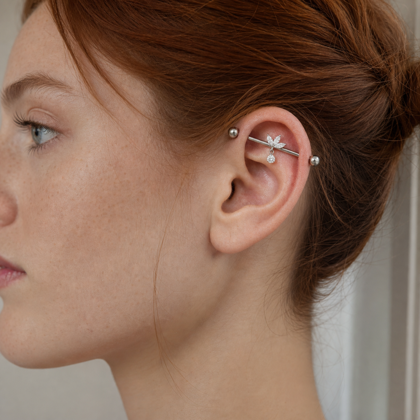 G23 Titanium Marquise Dangle Industrial Barbell Earring in Silver worn on ear in clean window daylight