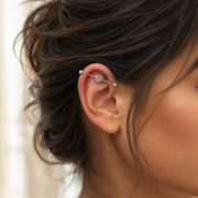 G23 Titanium Double Heart Industrial Barbell Earring in Silver worn on ear in clean window daylight