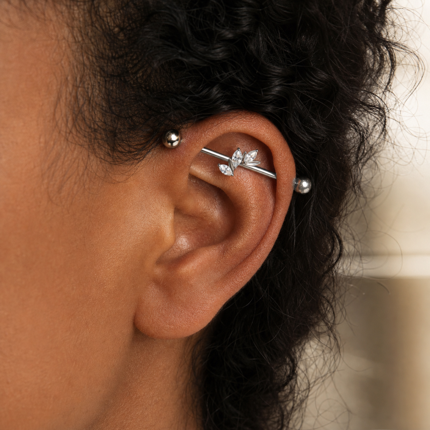 G23 Titanium Marquise Arc Industrial Barbell Earring in Silver worn on ear in clean window daylight