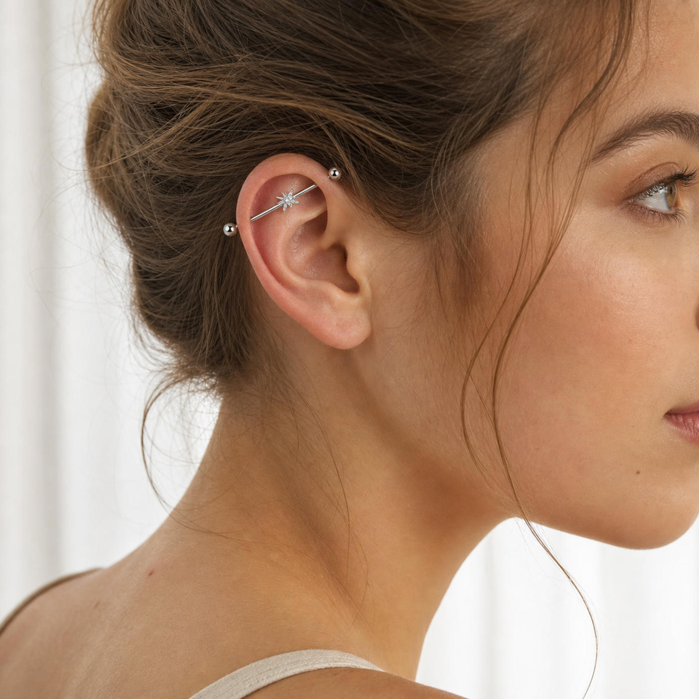 G23 Titanium North Star Crystal Industrial Barbell Earring in Silver worn on ear in clean window daylight