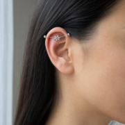 G23 Titanium Six Marquise Flower Industrial Barbell Earring in Silver worn on ear in clean window daylight