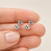 Titanium Ball Stud Earrings Polished Round for Sensitive Ears shown at fingertip scale