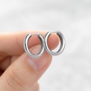 Titanium Hoop Earrings Rooftop Huggie for Sensitive Ears shown at fingertip scale