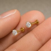Titanium Stud Earrings Crystal Clear for Sensitive Ears shown at fingertip scale