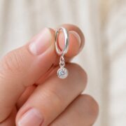 Hypoallergenic Hoop Earrings Crystal Birthstone with S925 Silver shown at fingertip scale