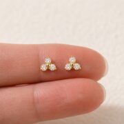 Flat Back Stud Earrings Pave Astrid in F136 Titanium shown at fingertip scale