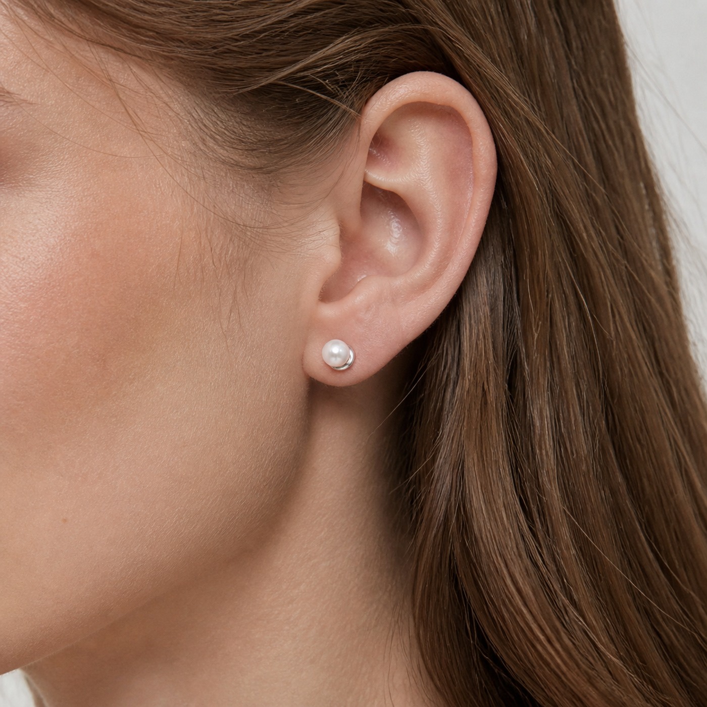 Titanium Pearl Flat Back Stud Earrings worn on one ear