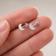 Flat Back Stud Earrings Classic Moon in F136 Titanium shown at fingertip scale