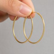 Hypoallergenic Hoop Earrings Every Body with S925 Silver shown at fingertip scale