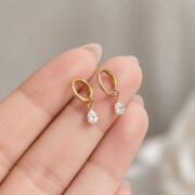 Titanium Hoop Earrings Teardrop Zircon for Sensitive Ears shown at fingertip scale
