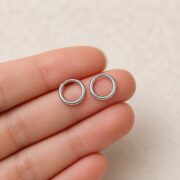Titanium Hoop Earrings Essential for Sensitive Ears shown at fingertip scale
