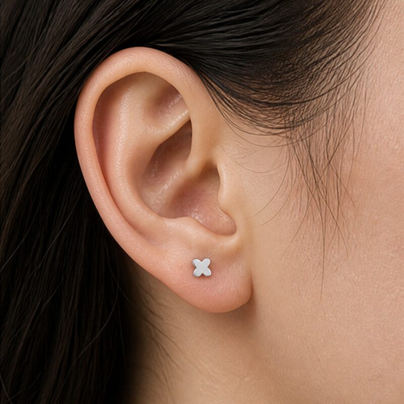 Flat Back Stud Earrings Tiny Four-Petal in F136 Titanium worn on one ear