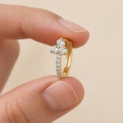 Hypoallergenic Hoop Earrings Kaia Crystal Lotus Pave Eternity with S925 Silver shown at fingertip scale