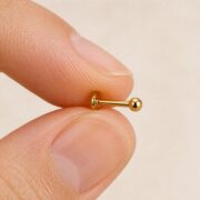 Flat Back Stud Earrings Val Polished Ball Ear in F136 Titanium shown at fingertip scale