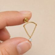 Flat Back Hidden Helix Crystal Chain Drop Earring in Titanium shown at fingertip scale