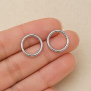 Titanium Hoop Earrings Ziv Simple Hinged Segment for Sensitive Ears shown at fingertip scale