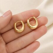 Titanium Hoop Earrings Brandy Chunky Dome Polished for Sensitive Ears shown at fingertip scale