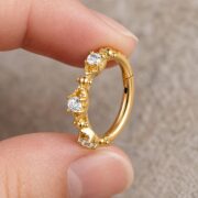 Hypoallergenic Hoop Earrings Couture Crystal Milgrain Eternity Hinged Segment with S925 Silver shown at fingertip scale