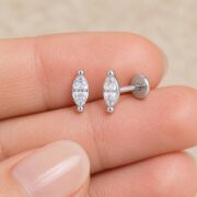 Titanium Stud Earrings Sparkly Marquise in Natural Titanium shown at fingertip scale