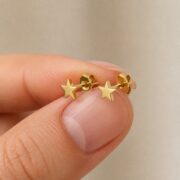 Titanium Stud Earrings Twinkle Little Star for Sensitive Ears shown at fingertip scale