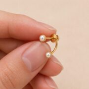 Stud Earrings Pearl Double Ear Jacket with S925 Silver shown at fingertip scale