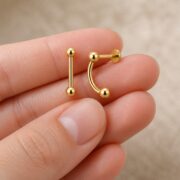 Titanium Stud Earrings Double Ball Ear Jacket for Sensitive Ears shown at fingertip scale