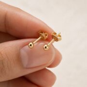 Stud Earrings Ball with S925 Silver shown at fingertip scale