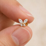Flat Back Stud Earrings Crystal Butterfly in F136 Titanium - fingertip scale view