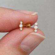 Flat Back Stud Earrings Opal Crystal Trio Bar in F136 Titanium shown at fingertip scale
