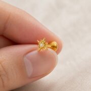 Flat Back Stud Earrings Crystal North Star in F136 Titanium shown at fingertip scale