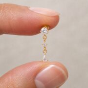 Flat Back Earrings Gold Linear Crystal Drop in F136 Titanium shown at fingertip scale