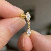 Flat Back Earrings Gold Kite Crystal Linked Drop in F136 Titanium shown at fingertip scale