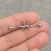 G23 Titanium Bunny Crystal Industrial Barbell Earring shown at fingertip scale