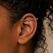 G23 Titanium Three Baguette Industrial Barbell Earring worn on one ear