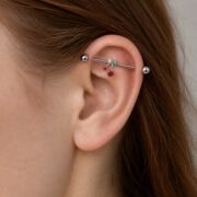 G23 Titanium Cherry Crystal Industrial Barbell Earring worn on one ear