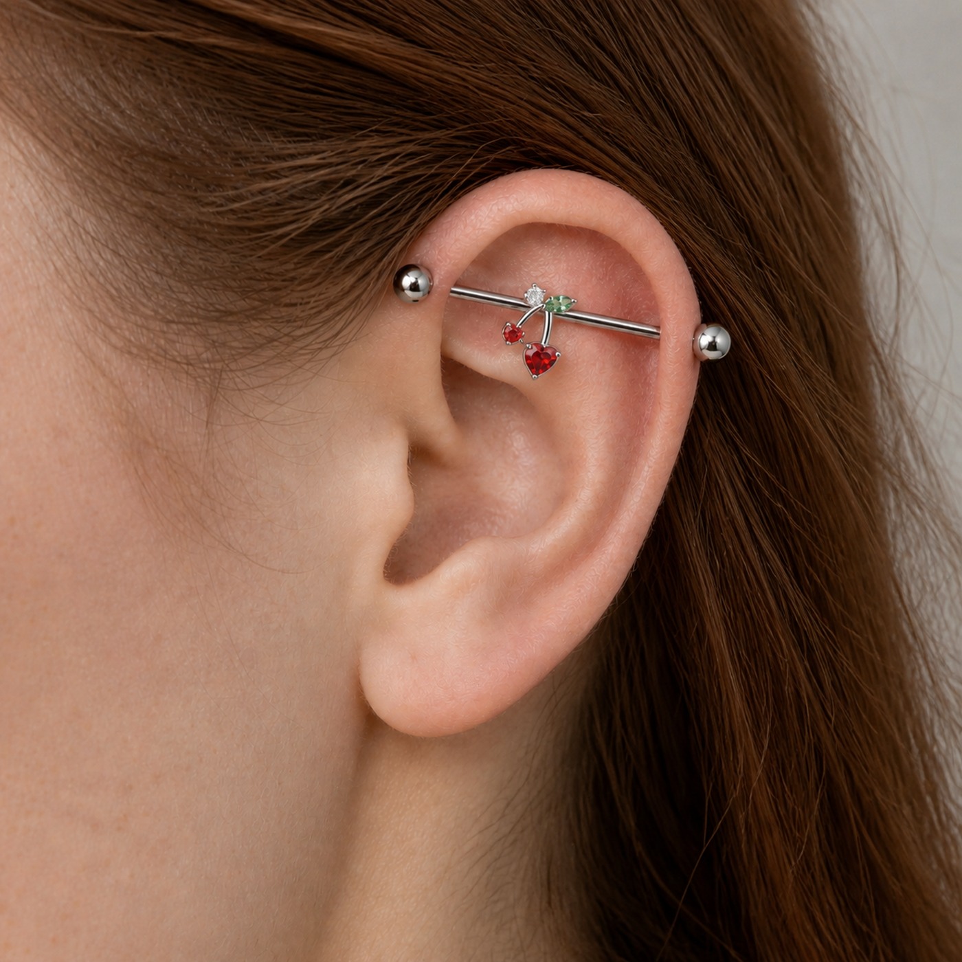 G23 Titanium Cherry Crystal Industrial Barbell Earring worn on one ear