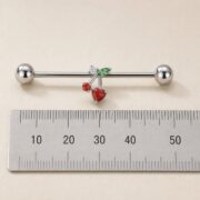 G23 Titanium Cherry Crystal Industrial Barbell Earring shown at fingertip scale