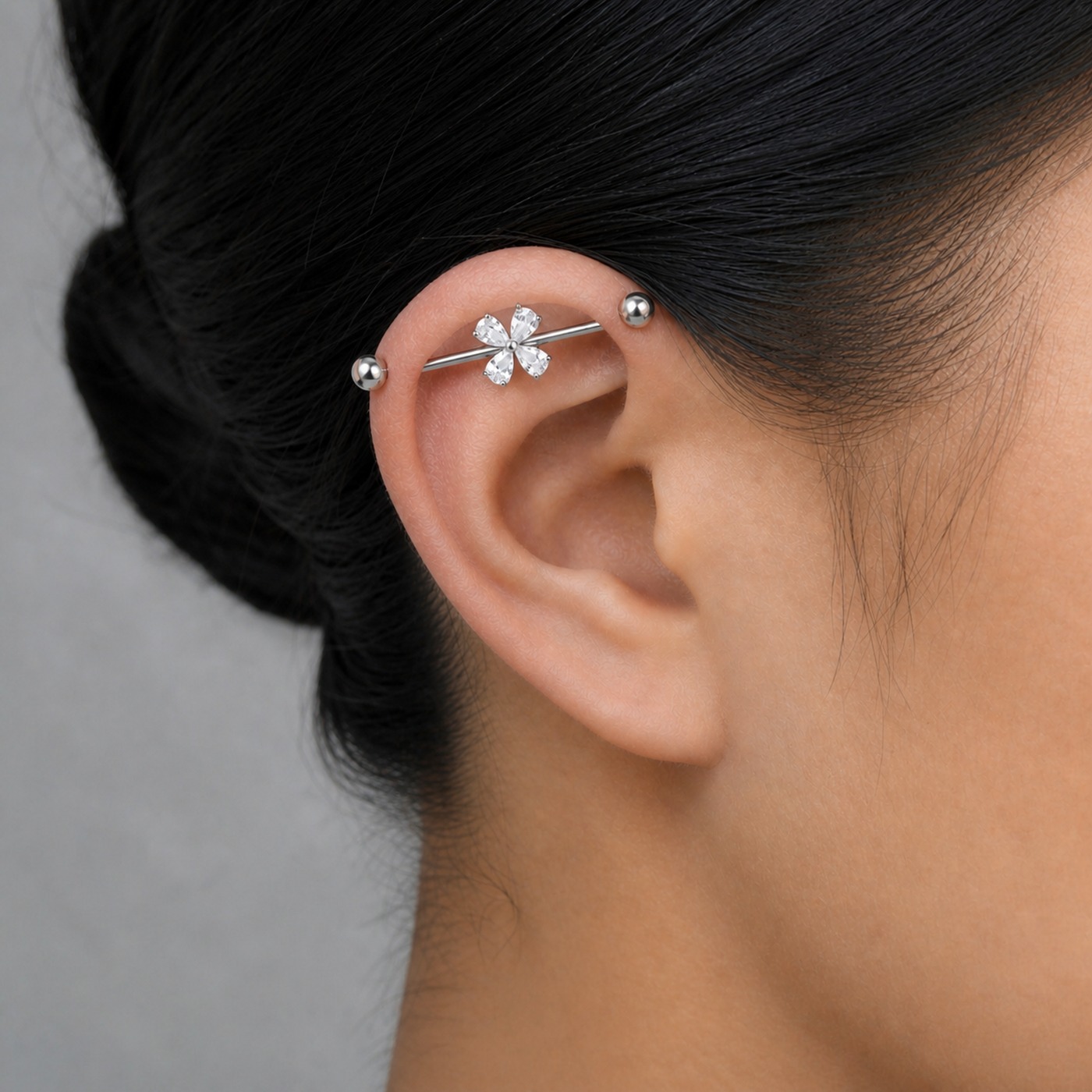 G23 Titanium Four-Petal Crystal Industrial Barbell Earring in Natural Titanium worn on one ear