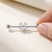 G23 Titanium Four-Petal Crystal Industrial Barbell Earring in Natural Titanium shown at fingertip scale