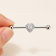 G23 Titanium Double Heart Industrial Barbell Earring in Natural Titanium shown at fingertip scale