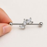 G23 Titanium Marquise Arc Industrial Barbell Earring in Natural Titanium shown at fingertip scale
