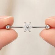 G23 Titanium Six Marquise Flower Industrial Barbell Earring in Natural Titanium shown at fingertip scale