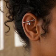 G23 Titanium Cherry Crystal Industrial Barbell Earring in Natural Titanium worn on one ear