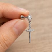 Flat Back Earrings Crystal Cross Dangle with F136 Titanium Post shown at fingertip scale