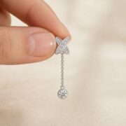 S925 Silver Full Diamond X Chain Drop Stud Earrings shown at fingertip scale