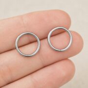 Titanium Hoop Earrings – Seamless Clicker for Cartilage shown at fingertip scale